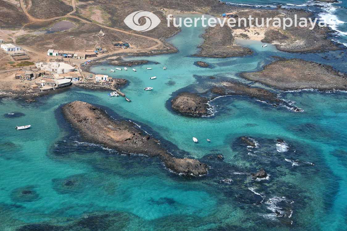 Scenic view of El Puertito on Los Lobos Island with its turquoise waters, white sandy beach, and surrounding natural coves.