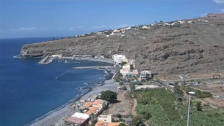 Bird's-eye view captured from the live webcam of Playa de Santiago, showing the pristine beach and surrounding landscapes of La Gomera.